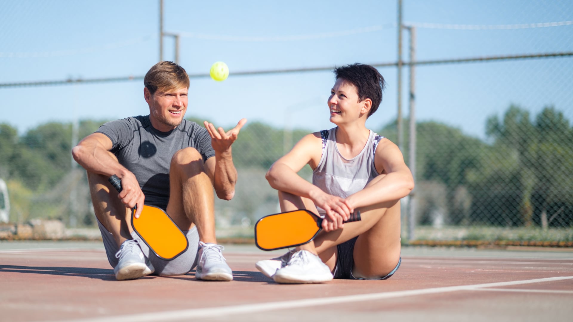 pickleball players couple sitting after game